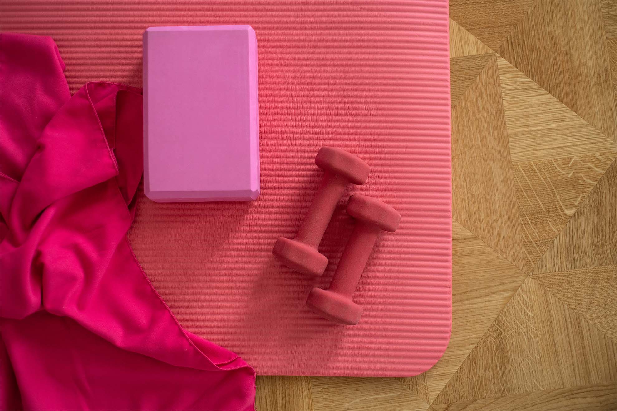 dumbbells on a pink yoga mat