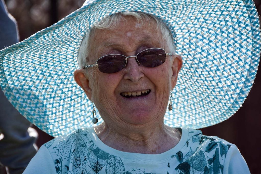 old lady with a blue jumper smiling