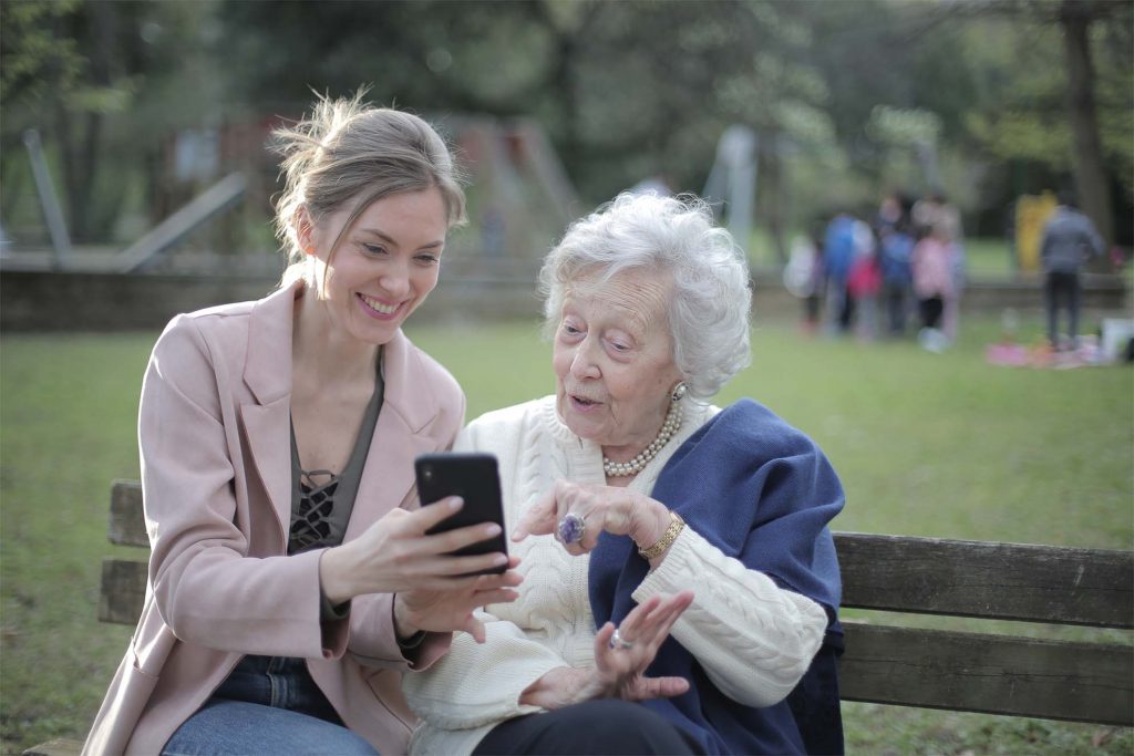lady helping resident with phone